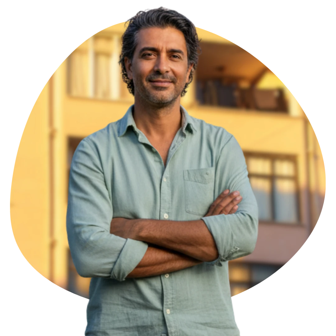 Middle-aged man standing with arms folded and a slight smile, representing a homeowner planning improvements to his property