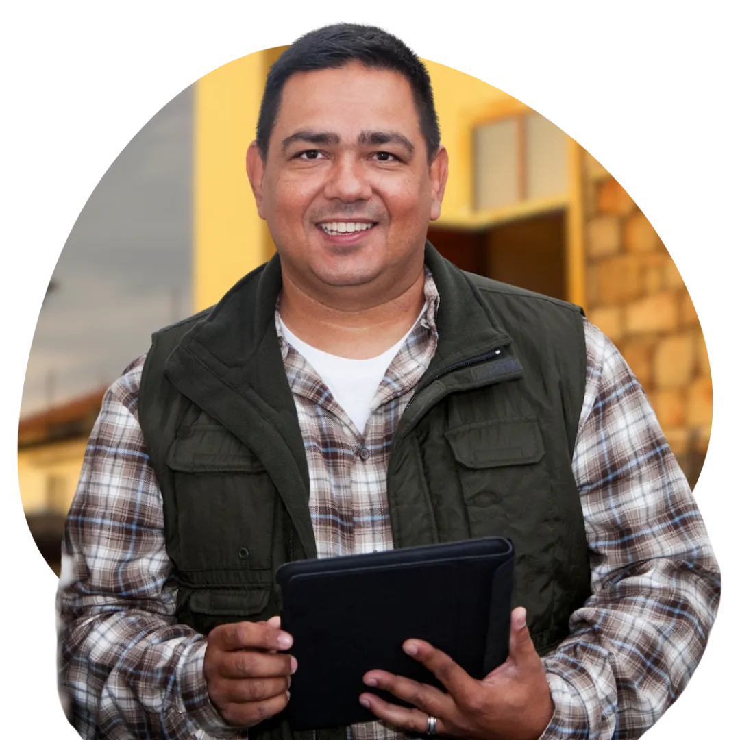 Middle-aged man standing with an iPad and smiling while reviewing personal finance options